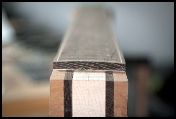 A 12" radius created on the surface of the fretboard