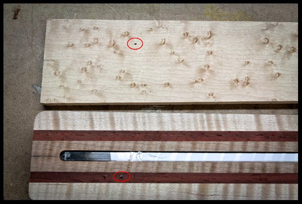 The locator pin and the equivalent hole on the fretboard