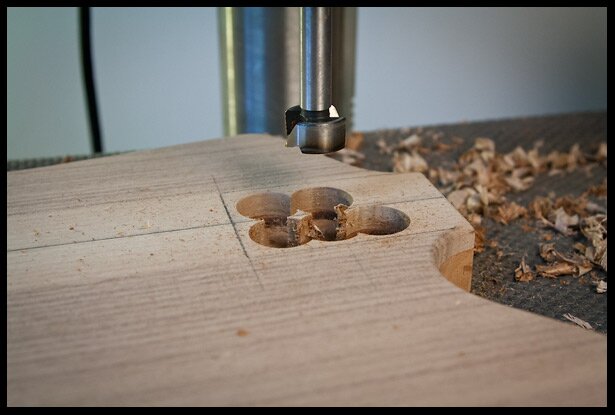 Carving the majority of the neck pocket with a Forstner bit