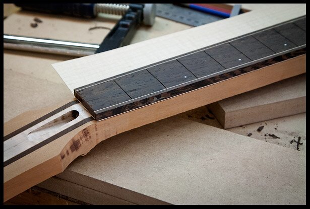 A look at the fretboard on the neck