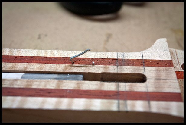 Locator pin for fretboard placement