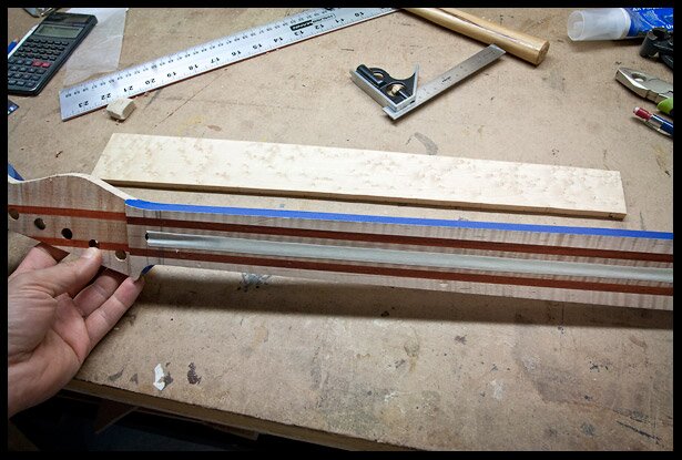 Place masking tape over the truss rod channel and the sides of the neck