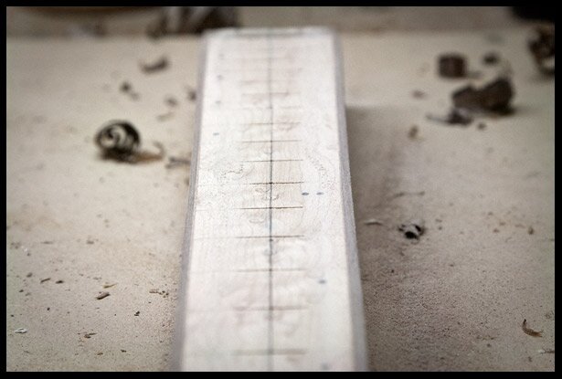 Fretboard with binding and in the process of adding a 12 degree radius