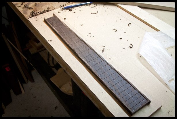 The fretboard is bound, needs some cleaning up