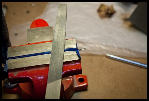 filing off some of the tang from the edges of the frets