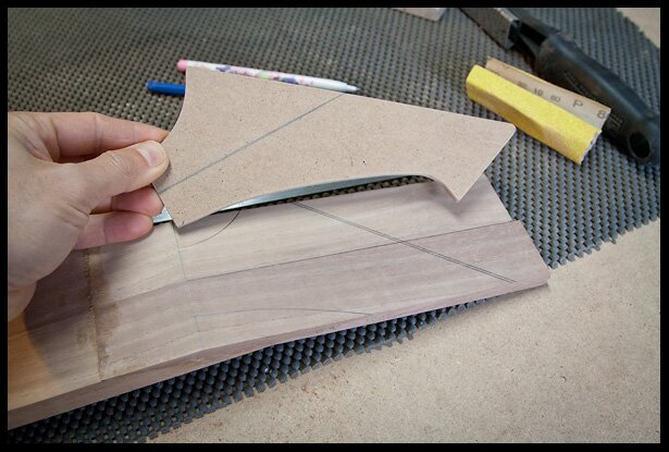tracing the headstock shape onto the peghead
