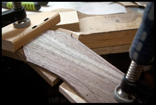 Placing the headstock veneer in position with a few finishing nails