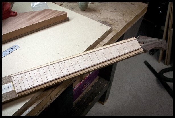 Fretboard glues onto neck