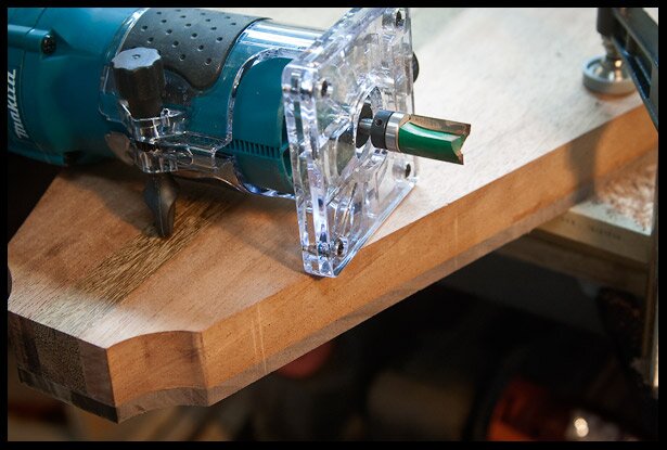 The walnut, which was slightly oversized is trimed using a trim router and a bit with a ball bearing.