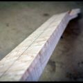 The truss rod and fingerboard are installed on the neck