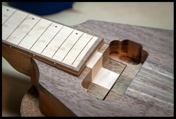 The neck heel fitting in the neck pickup cavity