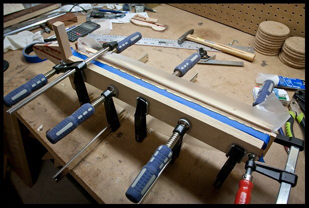 Clamp the fretboard to the neck using cauls