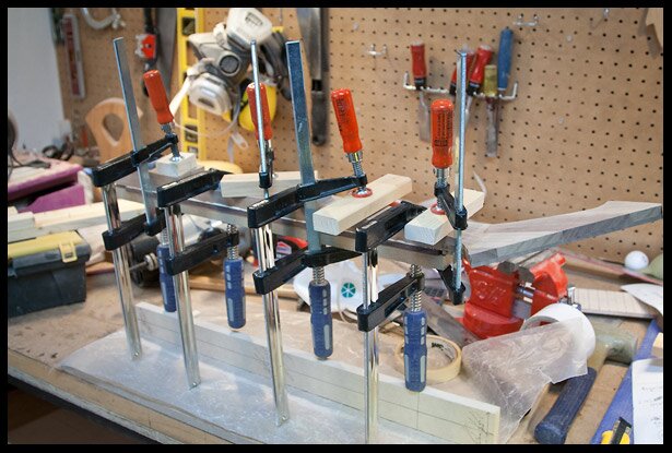 Clamping the fretboard to the neck. Allowing the glue to cure for 24 hours